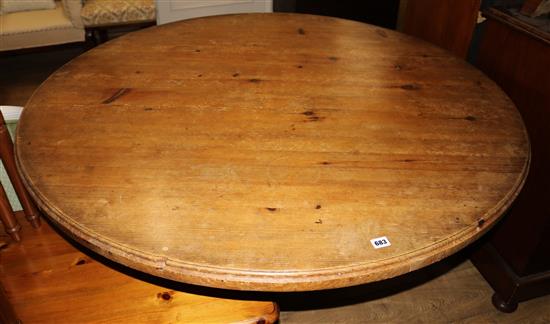 A circular pine table W.76cm